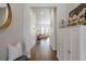 Welcoming foyer with hardwood floors, a decorative mirror, and stylish storage cabinet at 8503 Estes Park Ave, Littleton, CO 80125