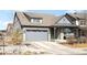Charming home featuring a two-car garage, covered porch, and well-maintained landscaping at 8503 Estes Park Ave, Littleton, CO 80125