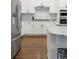 Modern kitchen with stainless steel appliances, granite countertops, and tile backsplash at 8503 Estes Park Ave, Littleton, CO 80125