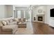 Inviting living room featuring a comfortable sectional sofa, fireplace, modern chandelier and sliding glass doors at 8503 Estes Park Ave, Littleton, CO 80125