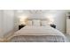 Serene main bedroom featuring a plush bed, bedside tables, lamps and a soft neutral color palette at 8503 Estes Park Ave, Littleton, CO 80125