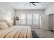 Comfortable main bedroom featuring neutral décor, a cozy bed and ample natural light at 8503 Estes Park Ave, Littleton, CO 80125