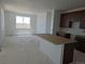 Bright open-concept kitchen and living space with island, ready for personalization at 6034 Keyser Pl, Brighton, CO 80601