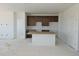 Spacious kitchen area with cabinets and island, awaiting appliances and finishing at 6034 Keyser Pl, Brighton, CO 80601