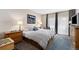Inviting bedroom boasts ample natural light, a work area, and a door leading to a balcony, creating a serene space at 720 Columbine Rd # B, Breckenridge, CO 80424