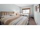 Bright bedroom with two beds, complemented by a window with outdoor views, offering a peaceful retreat at 720 Columbine Rd # B, Breckenridge, CO 80424