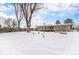 Large backyard with snow covered lawn at 209 Reed St, Lakewood, CO 80226