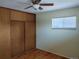 Bedroom with hardwood floors and large sliding closet doors at 209 Reed St, Lakewood, CO 80226