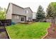 Beautiful backyard with well-maintained lawn, wooden deck, garden beds, and privacy fencing at 3101 Goldeneye Pl, Superior, CO 80027