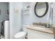 Bathroom with granite countertop, modern fixtures, decorative shelves, and integrated laundry at 3101 Goldeneye Pl, Superior, CO 80027