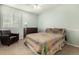 Cozy bedroom features a ceiling fan, large bed with a unique quilt, chair, and a window at 3101 Goldeneye Pl, Superior, CO 80027