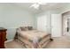 Bright bedroom features a ceiling fan, large bed with a unique quilt, and a closet at 3101 Goldeneye Pl, Superior, CO 80027