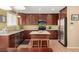 Modern kitchen featuring stainless steel appliances, granite countertops, and dark wood cabinetry at 3101 Goldeneye Pl, Superior, CO 80027