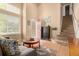 Inviting living room with high ceilings, staircase, and cozy seating area with hardwood floors at 3101 Goldeneye Pl, Superior, CO 80027