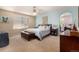 Relaxing main bedroom with a king-size bed, ceiling fan, and archway to a dressing area at 3101 Goldeneye Pl, Superior, CO 80027