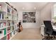 Well-lit office space features built-in bookshelves, storage cabinets, desk, and neutral color palette at 3101 Goldeneye Pl, Superior, CO 80027