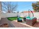 Backyard with artificial turf, brick patio, and outdoor lounge furniture at 8001 W 57Th Ave, Arvada, CO 80002