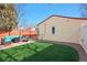 Backyard featuring artificial turf, brick patio with cozy outdoor furniture at 8001 W 57Th Ave, Arvada, CO 80002