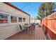 Backyard featuring wooden deck with outdoor seating and string lights at 8001 W 57Th Ave, Arvada, CO 80002