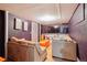 Finished basement featuring a lounge area with couches, a TV, and modern decor at 8001 W 57Th Ave, Arvada, CO 80002