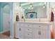 Stylish bathroom with double vanity, quartz countertop, and framed mirror at 8001 W 57Th Ave, Arvada, CO 80002