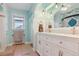Bright bathroom with a double sink vanity, fresh paint, modern lighting, and tile floors at 8001 W 57Th Ave, Arvada, CO 80002
