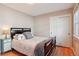 Bedroom features hardwood floors, closet, and a vintage side table with lamp at 8001 W 57Th Ave, Arvada, CO 80002