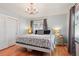 Bright bedroom with hardwood floors, a chandelier, and double windows offering ample natural light at 8001 W 57Th Ave, Arvada, CO 80002