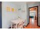 Cozy dining area with a white table, hardwood floors, and decorative wall art at 8001 W 57Th Ave, Arvada, CO 80002