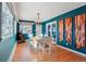 Dining area with a rustic wooden table, modern lighting, and stylish decor at 8001 W 57Th Ave, Arvada, CO 80002