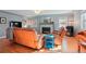 Bright living room with hardwood floors, a decorative fireplace, and comfortable leather furniture at 8001 W 57Th Ave, Arvada, CO 80002