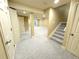 Spacious finished basement with neutral carpet, lighting, and a stairway at 12743 W Bowles Pl, Littleton, CO 80127