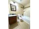 Bathroom featuring a tiled shower and tub and wood-tone sink and vanity at 12743 W Bowles Pl, Littleton, CO 80127