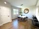 Bright dining room featuring modern lighting, a stylish table, and beautiful wood flooring at 12743 W Bowles Pl, Littleton, CO 80127