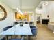 Open-concept dining area with wood floors, seamlessly connected to the modern kitchen and living spaces at 12743 W Bowles Pl, Littleton, CO 80127