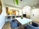 Open-concept dining area with wood floors, seamlessly connected to the modern kitchen and living spaces at 12743 W Bowles Pl, Littleton, CO 80127