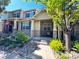 Charming townhome with stone accents, a cozy front porch, and a beautifully landscaped walkway at 12743 W Bowles Pl, Littleton, CO 80127