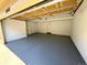 Clean two-car garage featuring painted walls and epoxy flooring at 12743 W Bowles Pl, Littleton, CO 80127