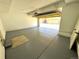 Clean two-car garage featuring painted walls and epoxy flooring at 12743 W Bowles Pl, Littleton, CO 80127