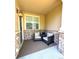 Inviting covered porch with stone accents, featuring comfortable seating and a stylish light fixture at 12743 W Bowles Pl, Littleton, CO 80127