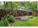 Fenced backyard shows a garden bed with planted vegetation, adjacent to a raised wood deck at 1672 Maccullen Dr, Erie, CO 80516