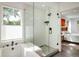 Modern bathroom features a glass walk-in shower, soaker tub, and neutral tile at 1672 Maccullen Dr, Erie, CO 80516