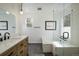 Bathroom features glass shower, soaking tub, vanity with sink, and modern finishes at 1672 Maccullen Dr, Erie, CO 80516