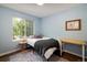 Bedroom with hardwood floors, blue accent wall, and large window at 1672 Maccullen Dr, Erie, CO 80516