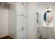 Hallway with cabinets leading into bathroom with vanity and commode at 1672 Maccullen Dr, Erie, CO 80516