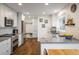Modern kitchen with stainless steel appliances, white cabinetry, hardwood floors, and views of the backyard at 1672 Maccullen Dr, Erie, CO 80516