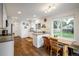 Bright kitchen featuring white cabinets, stainless steel appliances, and an eat-in dining area at 1672 Maccullen Dr, Erie, CO 80516
