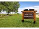 Erie Lake Open Space entrance sign surrounded by green grass, a wooden fence and open space at 1672 Maccullen Dr, Erie, CO 80516