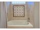 Relaxing bathroom with soaking tub and tile surround at 15119 E 119Th Ave, Commerce City, CO 80603