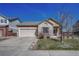 Brick ranch home with attached garage and landscaped yard at 15119 E 119Th Ave, Commerce City, CO 80603